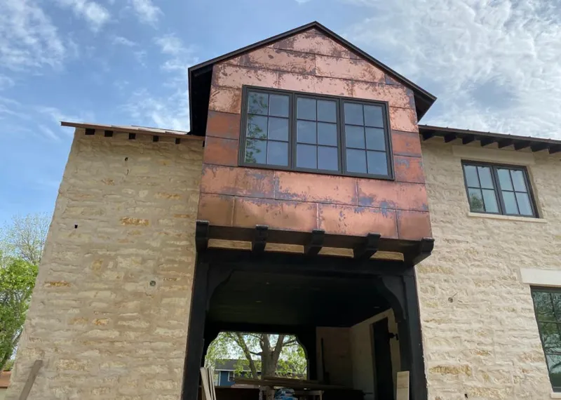 Copper metal panel facade on a stone building for Skylight Installation in Amelia