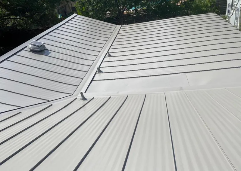 Solar attic fan installed on a metal roof for Roof Ventilation in Amelia